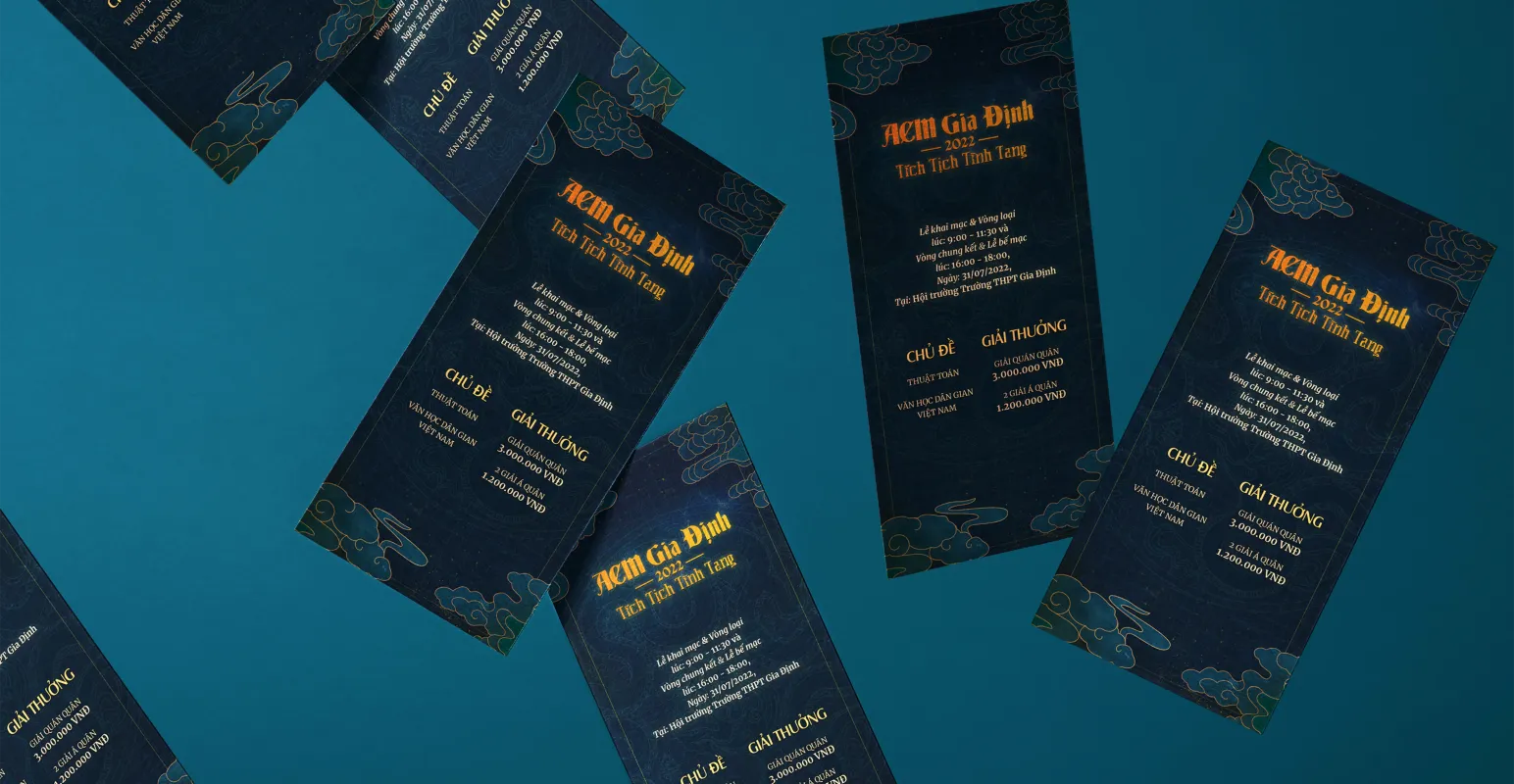 Photograph of scattered invitational brochures for the competition ACM Gia Dinh 2022. They are seen floating on a blue background.